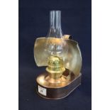 Early 20th century brass single burner hand lantern with flat reservoir, loop handles and curved