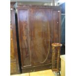 Edwardian inlaid mahogany wardrobe with blind panel door and foliate decoration over under