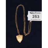 9 ct gold shield-shaped engraved fob on 9 ct gold chain. 6.7g approx. Case. (B.P. 21% + VAT)