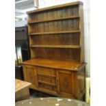 20th century oak dresser base on cup and cover supports with three drawers and two cupboards and a