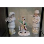 Pair of German continental figurines, together with another continental figure of a soldier. (B.P.