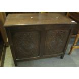 17th century style oak coffer having hinged lid with two carved lozenge foliate panels on stile