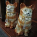 Pair of 20th century Staffordshire pottery seated ginger cats with glass eyes. 32 cm high approx. (