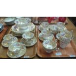 Two trays of 19th century tea ware items on a gilded and hand painted floral ground, to include cups