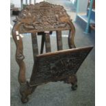 Oriental carved hardwood folding folio or magazine stand overall decorated with fantastic animals