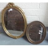 Modern gilt framed mirror of oval form with shell decoration together with a smaller oval bevel
