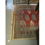 Modern red ground Middle Eastern deign rug decorated with central gulls. 131 x 185 cm approx. (B.