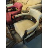 Two similar Edwardian ebonised and upholstered tub chairs on cabriole legs with ceramic casters. (2)