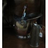 Brass helmet-shaped coal scuttle with swing handle, together with a copper and brass insulated jug