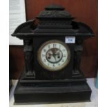 Late 19th century black slate architectural mantel clock having exposed escapement to the two-