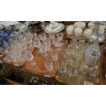 Three trays of assorted glass to include decanters and stoppers and various drinking vessels, some