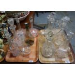 Two trays of assorted glass decanters of varying forms, all with stoppers. (2) (B.P. 21% + VAT)