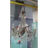 Large brass eight-branch chandelier over all with prismatic cut glass swags and droppers. (B.P.