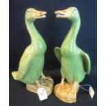 Two similar Chinese porcelain celadon glazed ducks on naturalistic bases, impressed marks. Modern.