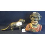 Cast metal novelty nutcracker in the form of a standing dog, together with a cast metal jolly