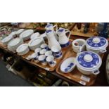 Five trays of Royal Worcester porcelain tea and dinnerware items on a blue and white ground,