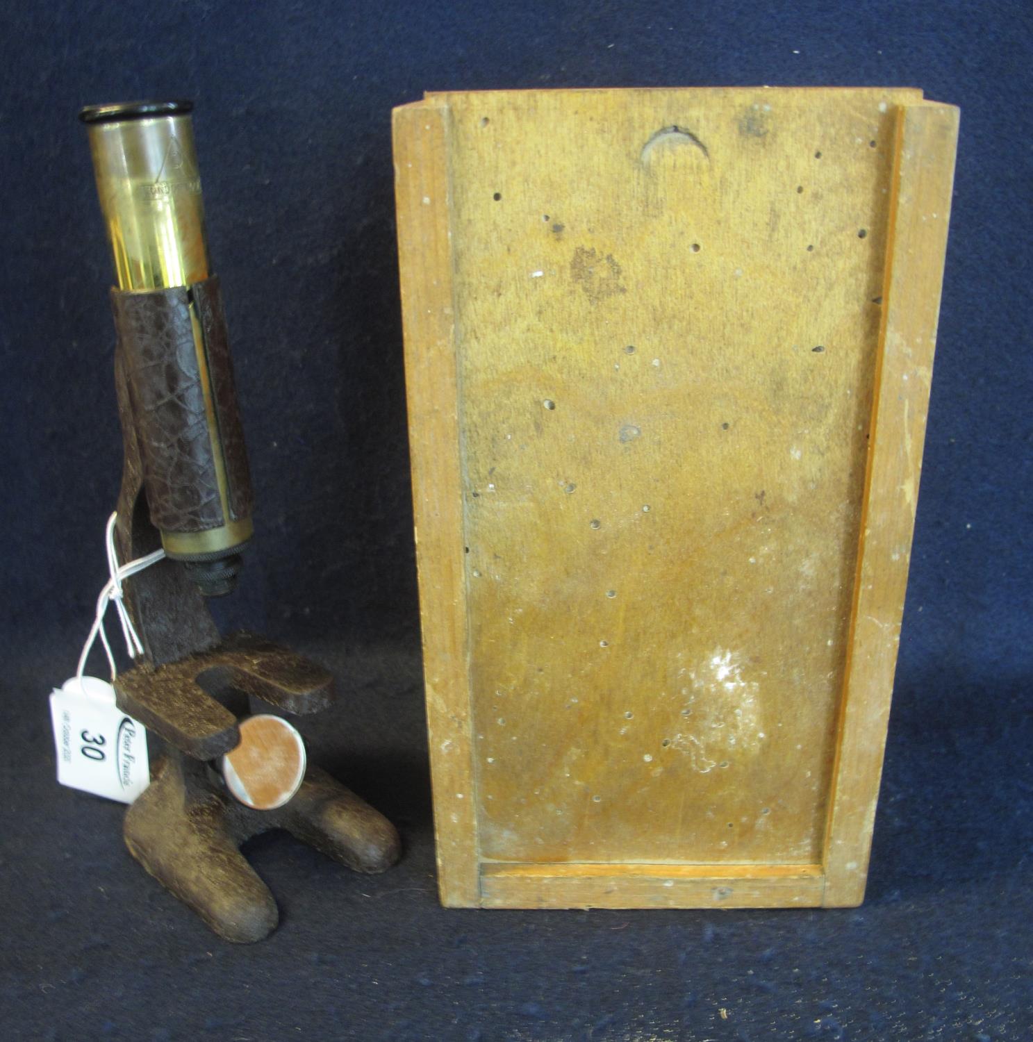 Small metal and brass students microscope, in original box, marked London Made. (B.P. 21% + VAT)