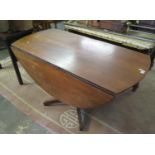 20th Century teak drop leaf table on quatreform base and cylinder pedestal. (B.P. 21% + VAT)