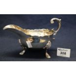 Large silver Georgian style sauce boat with card cut edge, scrolled handle and hoof feet. Birmingham