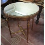 Onyx and gilded wooden occasional table of circular form on X frame support and mirrored top. (B.