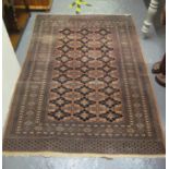Middle Eastern design carpet on a salmon ground with geometric foliate decoration. 129 x 176 cm
