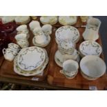 Two tray of Phoenix china part teaware on a white ground with gilded and floral swags . (2) (B.P.