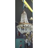 Gilt metal vase-shaped hanging centre light fitting overall with prismatic cut glass spangles and