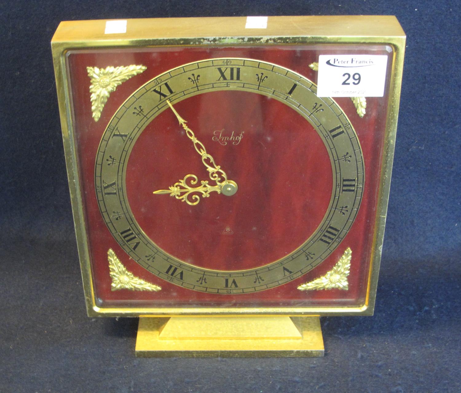 Imhof eight day Swiss mantel clock of square form on a gilt base, having gilt foliate mounts. Height