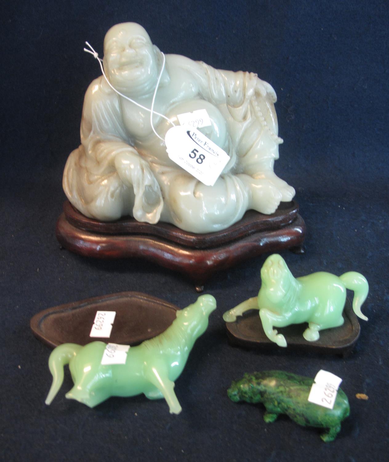 Chinese carved jade figure of a reclining smiling Buddha, together with two carved jade horses and a