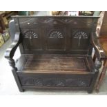 Early 20th Century stained oak open arm settle with box seat and fan carvings. (B.P. 21% + VAT)