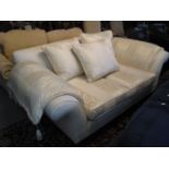 Good quality modern cream ground and gilded foliate two seater sofa with scroll ends and