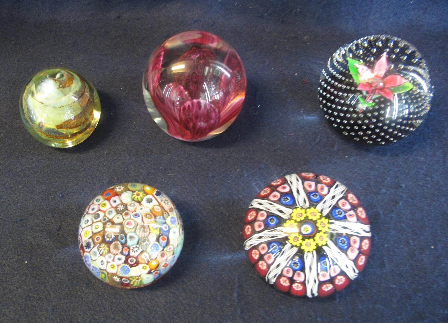 Collection of five art glass paperweights to include; Isle of Wight, Caithness and two caned