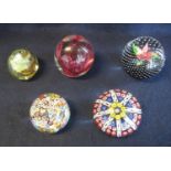Collection of five art glass paperweights to include; Isle of Wight, Caithness and two caned