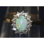 9ct gold oval opal and diamond ring. Ring size L & 1/2. Weight 2.5 grams approx. (B.P. 21% + VAT)