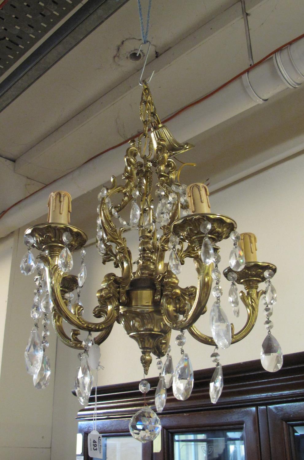 Gilt metal five branch Rococo style chandelier light fitting with prismatic glass droppers, together