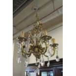 Gilt metal five branch Rococo style chandelier light fitting with prismatic glass droppers, together