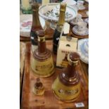 Tray of Wade Bell's Scotch whisky decanters, some sealed, together with two bottles of champagne,