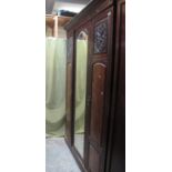 Edwardian mahogany and walnut three door wardrobe with mirror centre, hanging and base and