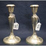 Pair of Adams style silver vase shaped repousse candlesticks with C scroll sconces and trailing