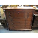 Victorian mahogany Scotch chest of drawers having shaped front and standing on baluster turned