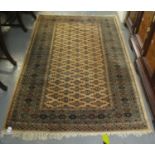 Middle Eastern design carpet on a beige ground with stylised foliate panels and geometric