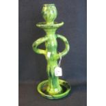 Ewenny pottery style candlestick on a green glazed ground with wrythen handles and circular base,