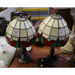 Pair of modern Tiffany style table lamps with lead glazed shades on cast metal bases. 40cm high