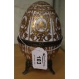 Decorative porcelain continental egg with metal mounts, overall on a white ground with gilded