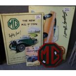 A group of MG motor cars ephemera to include; two metal signs (reproduction), a cast metal MG sign