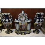Late Victorian Staffordshire pottery clock garniture, the clock of architectural form with a pair of