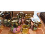 Collection of graduated Wade copper lustre dresser jugs, together with other dresser jugs and a