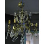 Circular gilt metal Art Deco style, three tier centre light fitting with prismatic glass spangles