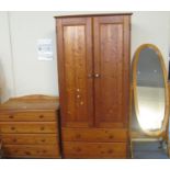 Modern pine two door wardrobe together with a similar pine straight front chest of four drawers, and