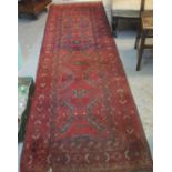 Middle Eastern design runner on a red ground. Central panel of foliate and geometric decorations. 90